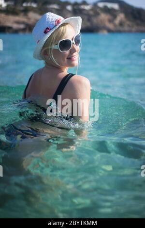 beautiful blonde woman swimming in the sea Stock Photo