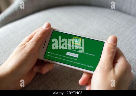 A girl uses Google Classroom mobile app to join an online class from her smartphone. Stock Photo