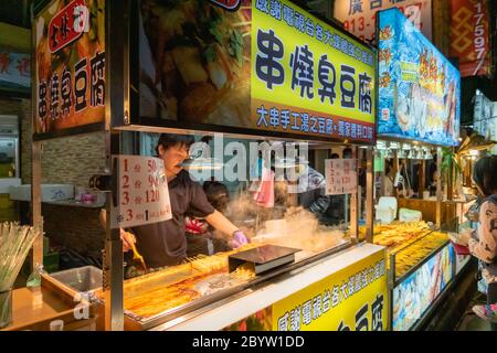 Taipei, Taiwan - March 2019: Stinky Tofu Street food vendor at Shilin night market. Stock Photo