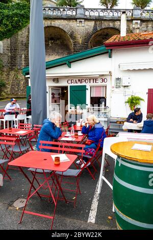 People dining al fresco at restaurants in Le Port des Pêcheurs fishing port, Biarritz, France Stock Photo
