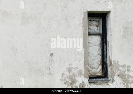 Boarded building window with burnt discolored planks. Stock Photo