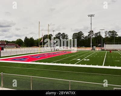 New colorful artificial turf at the end zone and goal post of a high school football field in Pike Road Alabama, USA. Stock Photo