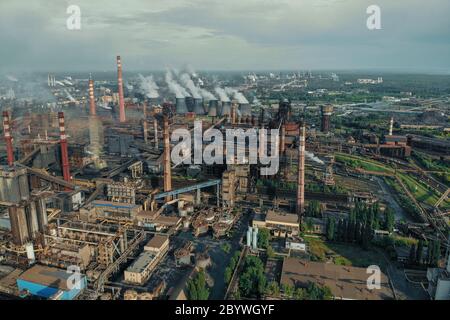 Aerial view of huge Metallurgical Plant, smokestacks and chimneys with smoke. Environmental pollution from petrochemical production industrial factory. Stock Photo