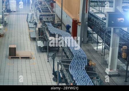 Modern automated beer bottling production line. Beer bottles moving on ...