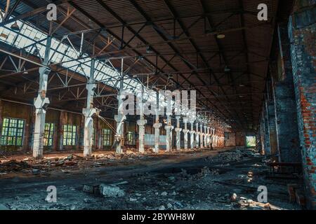 Dirty abandoned ruined industrial building inside, toned Stock Photo