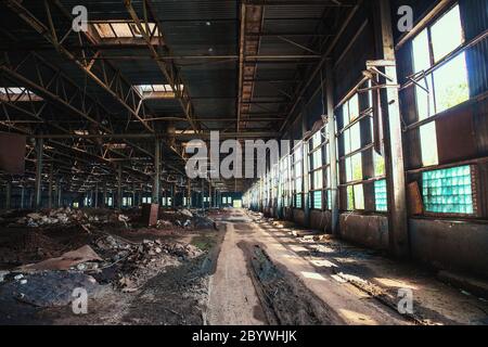 Dirty abandoned ruined industrial building inside, toned Stock Photo