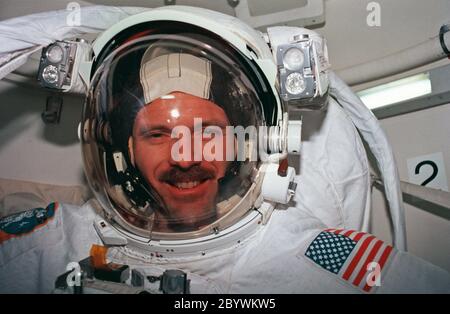 STS082-344-018 (11-21 Feb. 1997) --- Attired in the Extravehicular Mobility Unit (EMU) space suit, astronaut Steven L. Smith, mission specialist, is in the airlock of Discovery preparing for one of five STS-82 spacewalks. The sessions of extravehicular activity (EVA), of which Smith eventually participated in three, were conducted in order to service the Hubble Space Telescope (HST), temporarily latched in Discovery's payload bay. Stock Photo