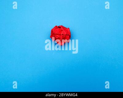 Successful idea concept, red crumpled sheet of paper on blue background Stock Photo