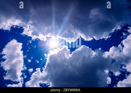 Uva and uvb rays of the sun pass through the atmosphere and the clouds to the skin of people. Stock Photo
