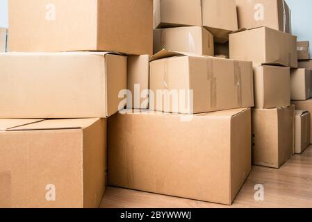 Detail of many cardboard boxes full of household items during a move. Stock Photo