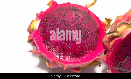 Dragon fruit slices with blushed red flesh. Dragon fruit contains 70% water and vitamins, suitable for use as a diet menu Stock Photo