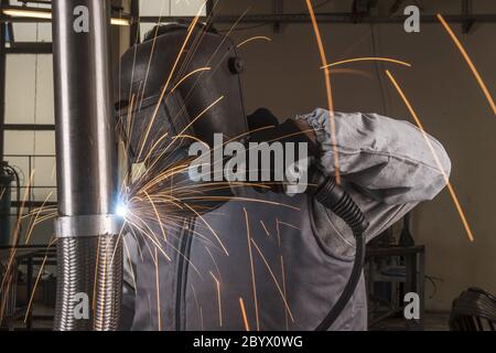 industrial arc welder working in factory Stock Photo