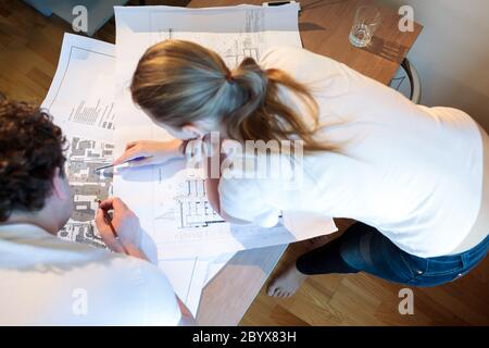 Young architects working with map and blueprint Stock Photo