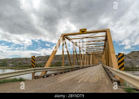 Wide angle view of Highway 848 bridge crossing the Red Deer River west of Dorothy. Southeast of Drumheller, Alberta, Canada in springtime. Stock Photo