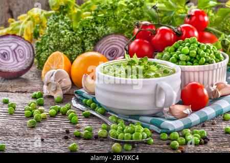 Homemade potage soup made from healthy peas with vegetable decoration Stock Photo