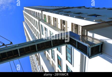 Selective focus of electrical cable tray connected to skyscraper for electric power transmission Stock Photo