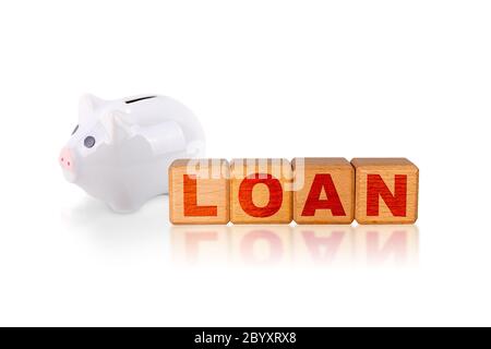 Concept of loan with word engraved on wooden alphabet cube blocks with piggy coin bank isolated on white background. Stock Photo