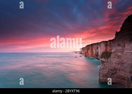 fire sunrise over cliffs in Atlantic ocean, France Stock Photo - Alamy