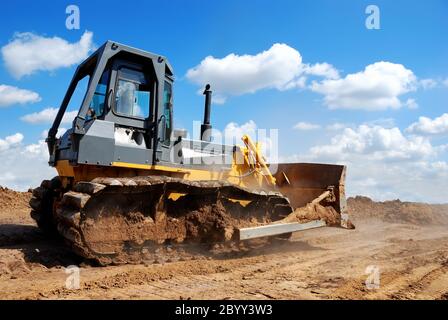 bulldozer with raised blade in action Stock Photo