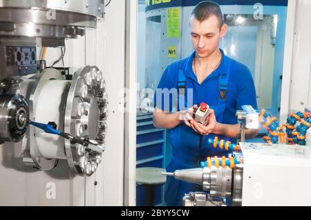 worker operating CNC machine center Stock Photo