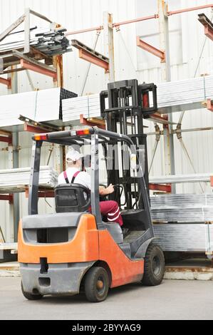 worker driver at warehouse forklift loader works Stock Photo