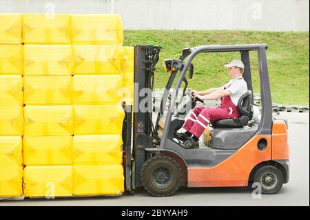 worker driver at warehouse forklift loader works Stock Photo