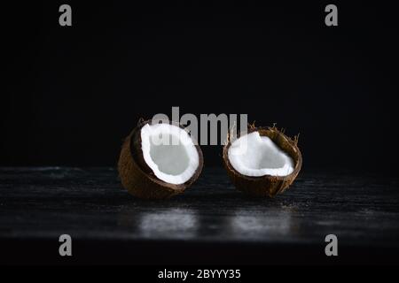 Coconut with half on a dark background. Organic healthy food concept. Stock Photo