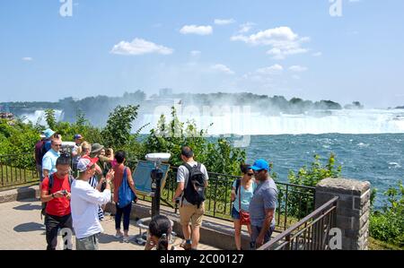 Niagara Falls, Canada - July 27, People taking selfie over Niagara Falls on a beautiful clear sunny day. Canadian view. Niagara Falls are three waterf Stock Photo