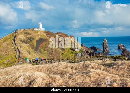 Lighthouse in Seopjikoji Mount Jeju Island , South Korea Stock Photo