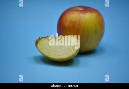Fresh apple with slice on blue background Stock Photo