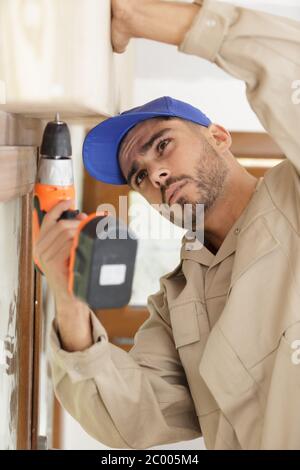 young builder using corless drill Stock Photo