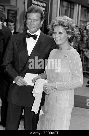 LONDON, UK. July 1980: Actor Roger Moore & wife Luisa Mattioli at the premiere of 'Sea Wolves' in London. © Paul Smith/Featureflash Stock Photo