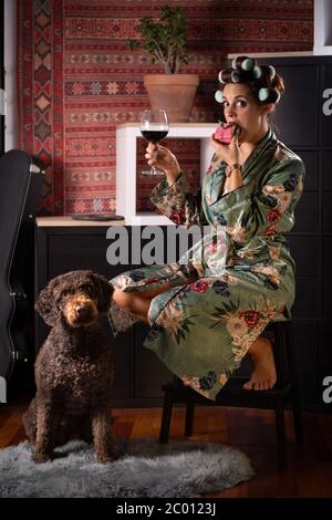 Caucasian young woman celebrating her birthday alone with her dog at home Stock Photo