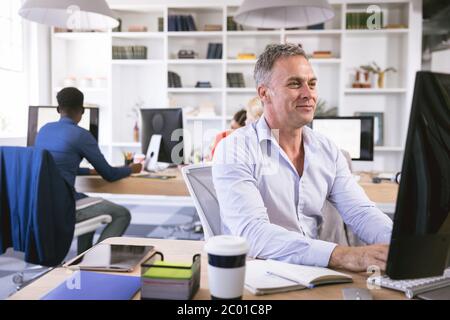 Multi races happy businesspeople working in a workspace Stock Photo