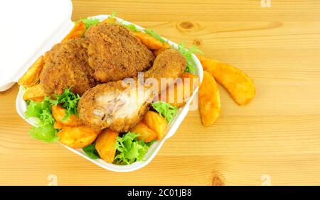 Southern fried chicken portions in a take away box on a wood background Stock Photo