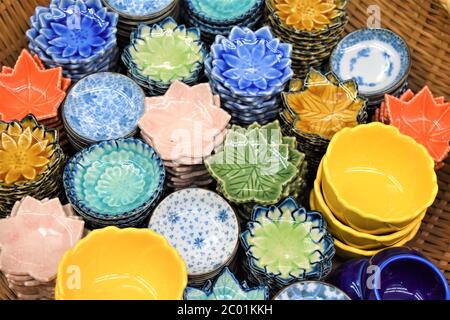 Round and flower shaped porcelain saucers and bowls in different colors and designs Stock Photo