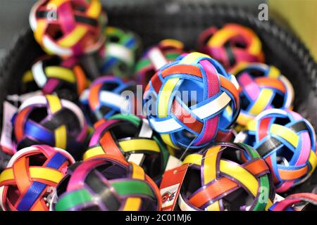 A pile of decorative handmade wicker balls in different bright colors are strewn in a basket Stock Photo