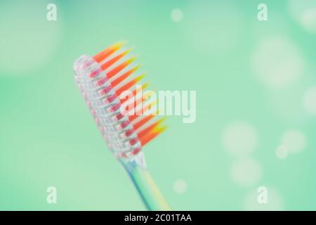 New plastic toothbrush on a green background with bubbles. Stock Photo