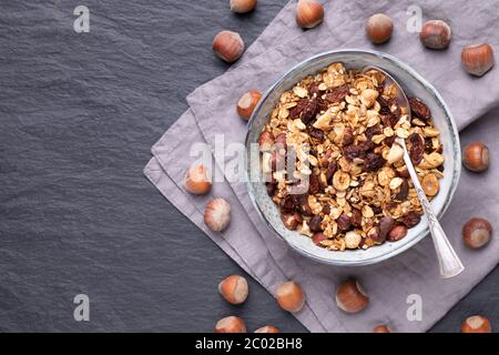 Homemade granola with nuts, raisins and seeds in bowls, good choice for breakfast or healthy snack Stock Photo