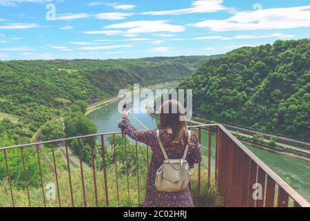 Summer sunny lifestyle fashion portrait of young stylish hipster woman walking in mountains, wearing cute trendy outfit, smiling enjoy weekends, trave Stock Photo