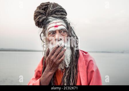 Portrait of sadhu smoking in the boat, Varanasi, India. Stock Photo