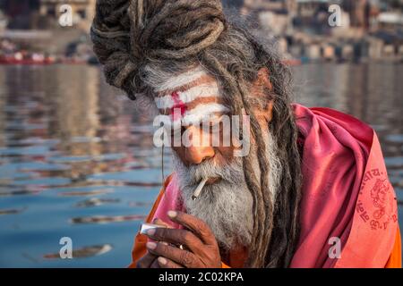 Portrait of sadhu smoking in the boat, Varanasi, India. Stock Photo