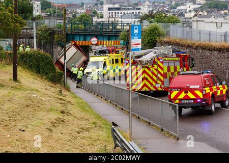 Cork, Ireland. 11th June, 2020. Truck Crashes into Bridge, Blackpool, Cork City. Just before 10am today emergency services were called to the scene an incident where an articulated truck collided with a railway bridge on Dublin Hill. The truck turned onto its side when it crashed into the bridge. There are reports that there are no injuries. Emergency Services are still on the scene. Traffic will see major delays in the area with the road closure and possible train delays till the bridge is inspected. Credit: Damian Coleman/Alamy Live News Stock Photo