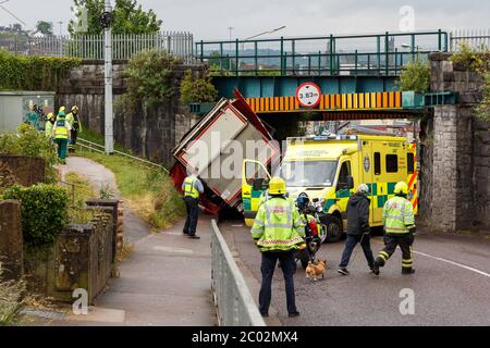 Cork, Ireland. 11th June, 2020. Truck Crashes into Bridge, Blackpool, Cork City. Just before 10am today emergency services were called to the scene an incident where an articulated truck collided with a railway bridge on Dublin Hill. The truck turned onto its side when it crashed into the bridge. There are reports that there are no injuries. Emergency Services are still on the scene. Traffic will see major delays in the area with the road closure and possible train delays till the bridge is inspected. Credit: Damian Coleman/Alamy Live News Stock Photo