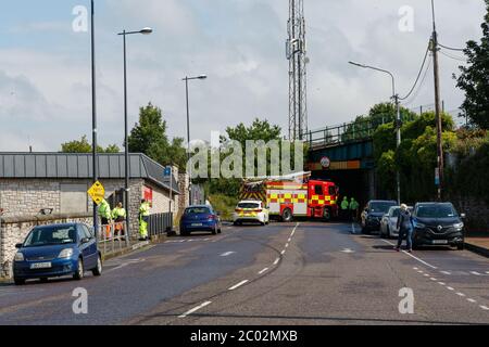 Cork, Ireland. 11th June, 2020. Truck Crashes into Bridge, Blackpool, Cork City. Just before 10am today emergency services were called to the scene an incident where an articulated truck collided with a railway bridge on Dublin Hill. The truck turned onto its side when it crashed into the bridge. There are reports that there are no injuries. Emergency Services are still on the scene. Traffic will see major delays in the area with the road closure and possible train delays till the bridge is inspected. Credit: Damian Coleman/Alamy Live News Stock Photo