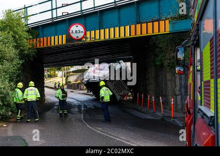 Cork, Ireland. 11th June, 2020. Truck Crashes into Bridge, Blackpool, Cork City. Just before 10am today emergency services were called to the scene an incident where an articulated truck collided with a railway bridge on Dublin Hill. The truck turned onto its side when it crashed into the bridge. There are reports that there are no injuries. Emergency Services are still on the scene. Traffic will see major delays in the area with the road closure and possible train delays till the bridge is inspected. Credit: Damian Coleman/Alamy Live News Stock Photo