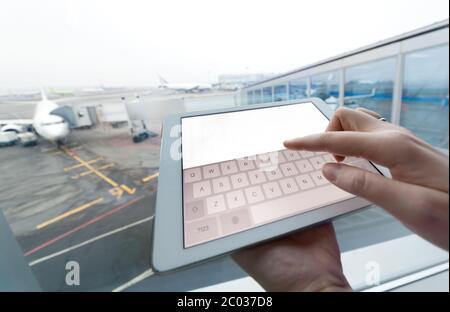 Woman with tablet computer empty screen at airport Stock Photo