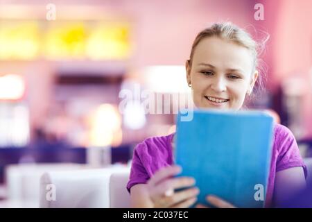 Woman using tablet PC in the restaurant indoors Stock Photo