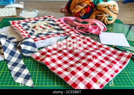 closeup sewing tools , patchwork,  - working environment on a cutting mat, pieces of colored patchwork fabric, Stock Photo