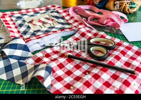 closeup sewing tools , patchwork,  - working environment on a cutting mat, pieces of colored patchwork fabric, Stock Photo